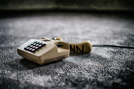 selective focus photo of white and black telephone thumbnail