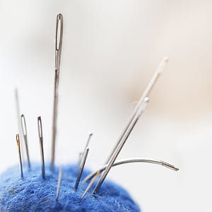 closed up photo of thread needle thumbnail