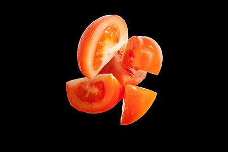 sliced tomato on black background thumbnail