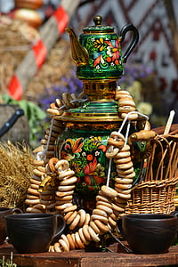 closeup photography of green and brass-colored floral pot on table near cups during daytime thumbnail