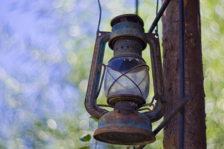 selective focus photography of blue kerosene lantern thumbnail