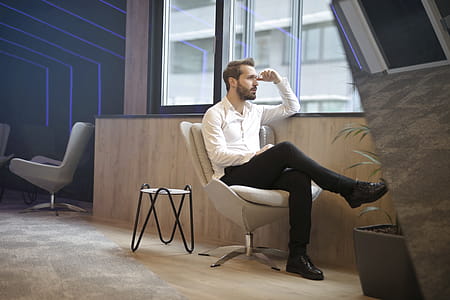 Photo of a Man Sitting Near the Windoww thumbnail
