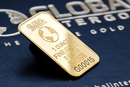 rectangular gold Global Intergold 1 ounce fine gold on blue surface thumbnail