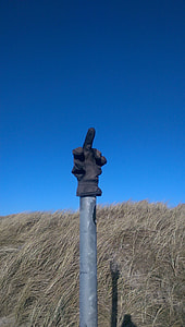 black glove on gray metal post during day thumbnail