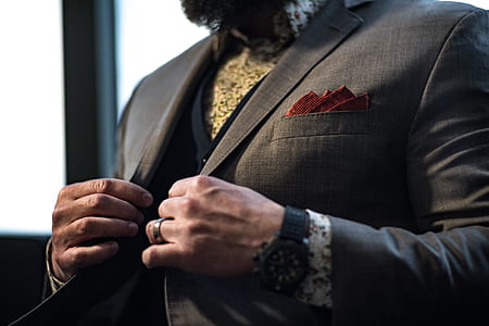 man holding his black notched lapel suit jacket thumbnail