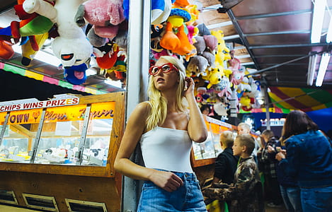 woman leaning on gray stand near plush toy lot thumbnail