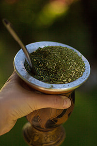 person holding stainless steel cup with matcha thumbnail