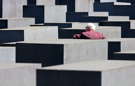 man standing beside concrete wall thumbnail
