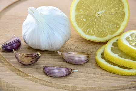 garlic, American lemon, and onion on table thumbnail