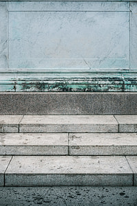 gray concrete stairs in front of teal wall thumbnail