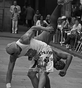grayscale photo of man dancing on street thumbnail