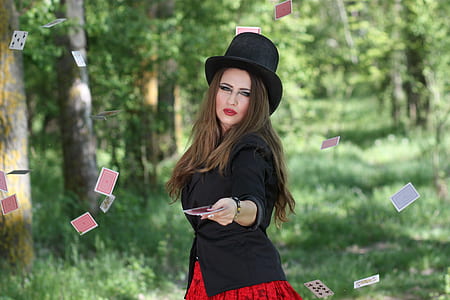 woman in black blazer doing card magic thumbnail