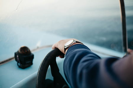 selective focus photography of person steering vehicle's wheel thumbnail