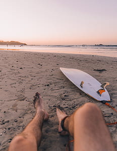 person lying on sand beach thumbnail