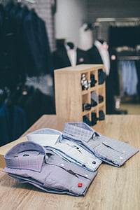 gray and white collared tops on brown table surface thumbnail