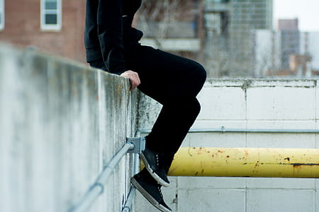 person wearing long-sleeved shirt and black pants thumbnail