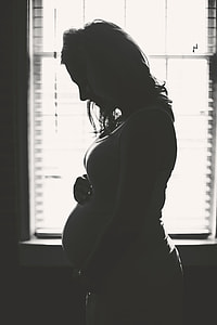 pregnant woman near window thumbnail