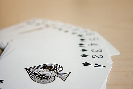 playing cards on brown wooden table thumbnail
