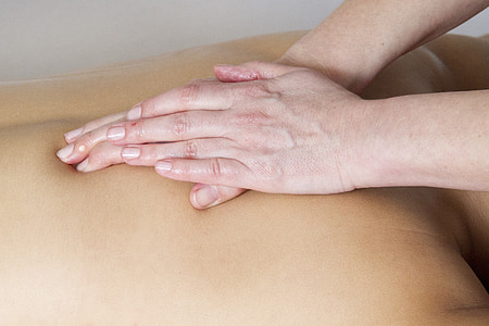 person massaging the back of another person thumbnail
