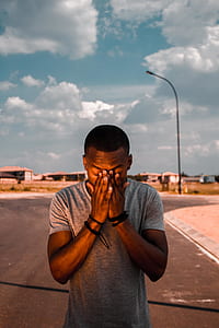 man holding her face during cloudy sky thumbnail
