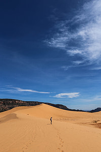 woman standing on sand during daytime thumbnail