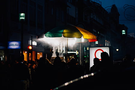 people gathering near umbrella thumbnail