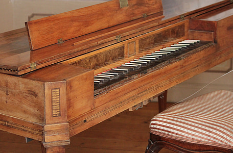 brown spinet piano beside chair thumbnail