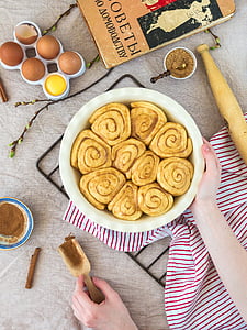right human hand holding ceramic bowl with pastry thumbnail