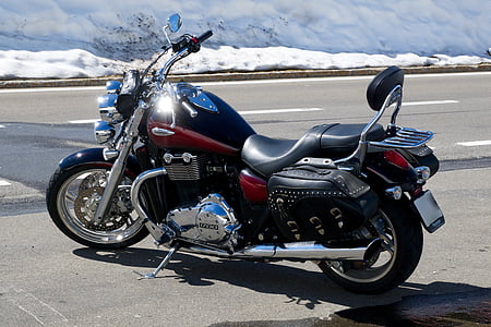 black and red cruiser motorcycle on concrete road at daytime thumbnail