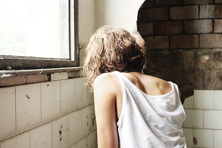 woman standing near ceramic tile wall inside room thumbnail
