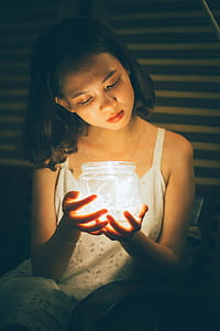 Woman Holding Decorative Jar With String Lights thumbnail