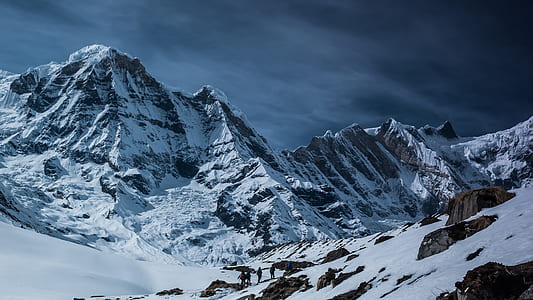 snow capped mountain under grey clouds thumbnail