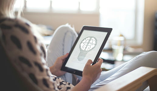 woman holding iPad while sitting thumbnail