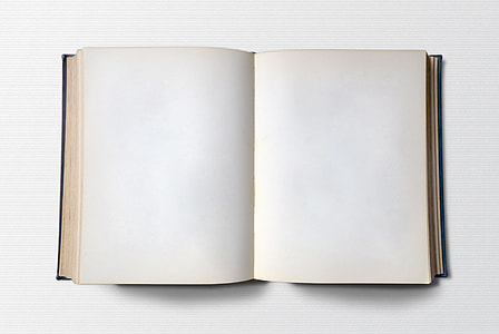 white opened blank book on top of white surface thumbnail