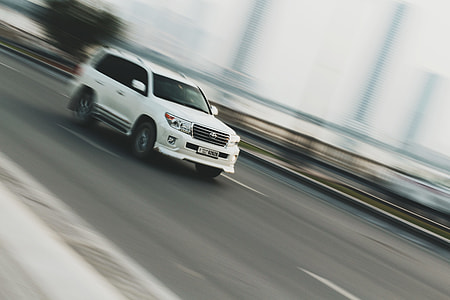 white Toyota SUV traveling on road thumbnail