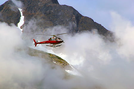 Red Helicopter on Top of Foggy Mountain thumbnail