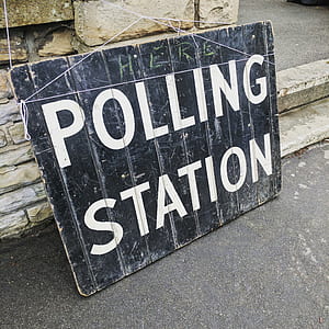 polling station signage beside wall thumbnail