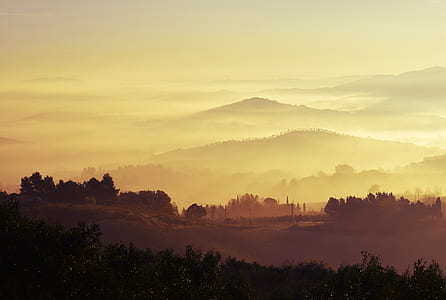 silhouette of mountains under yellow sky during daytime thumbnail