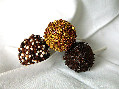 three chocolate pastries on white textile thumbnail