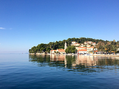 houses on island under blue sky thumbnail