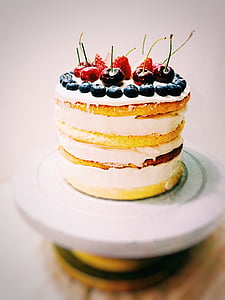 round white coated icing cake with cherry, strawberries and cranberries on top thumbnail