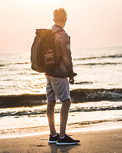 man standing near shoreline thumbnail