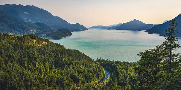 landscape photography of lake surrounded by mountains thumbnail