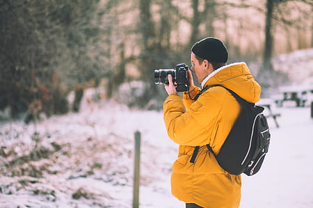 selective focus photography of man taking photo thumbnail