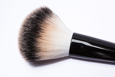 women's makeup brush on white surface thumbnail