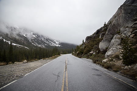 gray road surrounded by mountains thumbnail