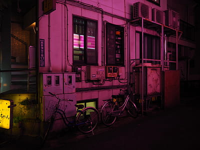 two bicycles park near beside building thumbnail