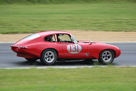 red Porsche stock car running on road thumbnail
