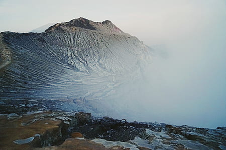 aerial photography of brown mountain surrounded by white cloud thumbnail