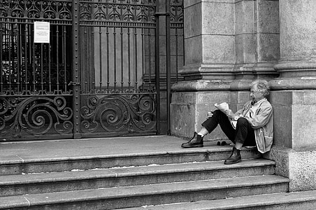 grayscale of of man sitting on stair thumbnail